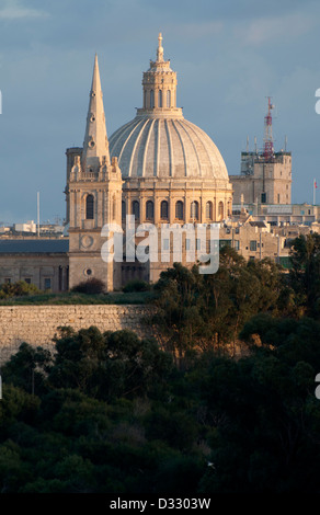 Valletta, St. John`s Co Cathedral, evening sun, trees in foreground, blue/grey sky, wintry Stock Photo
